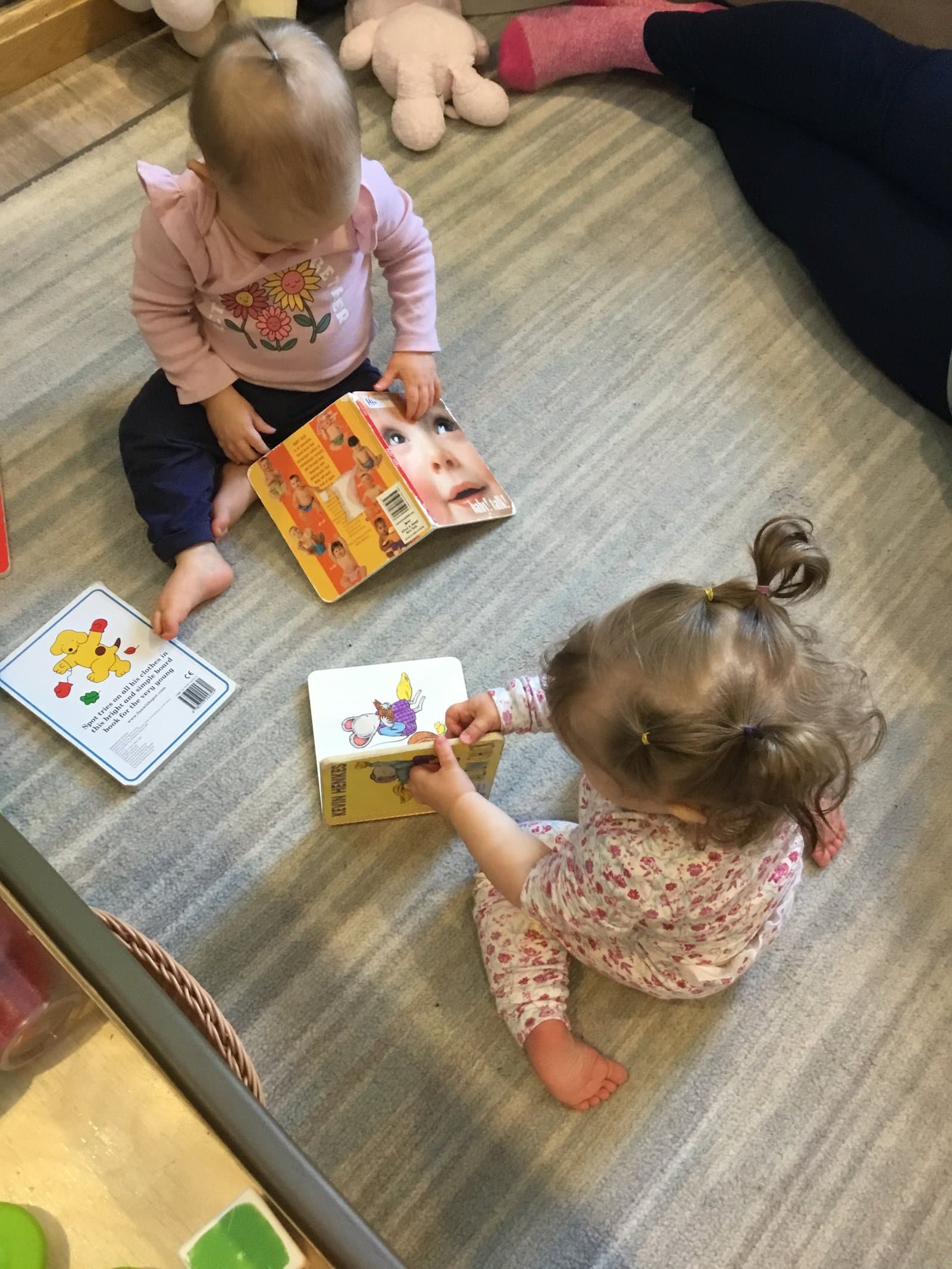 Infants reading picture books at Little Acorns Learning Center in Erie