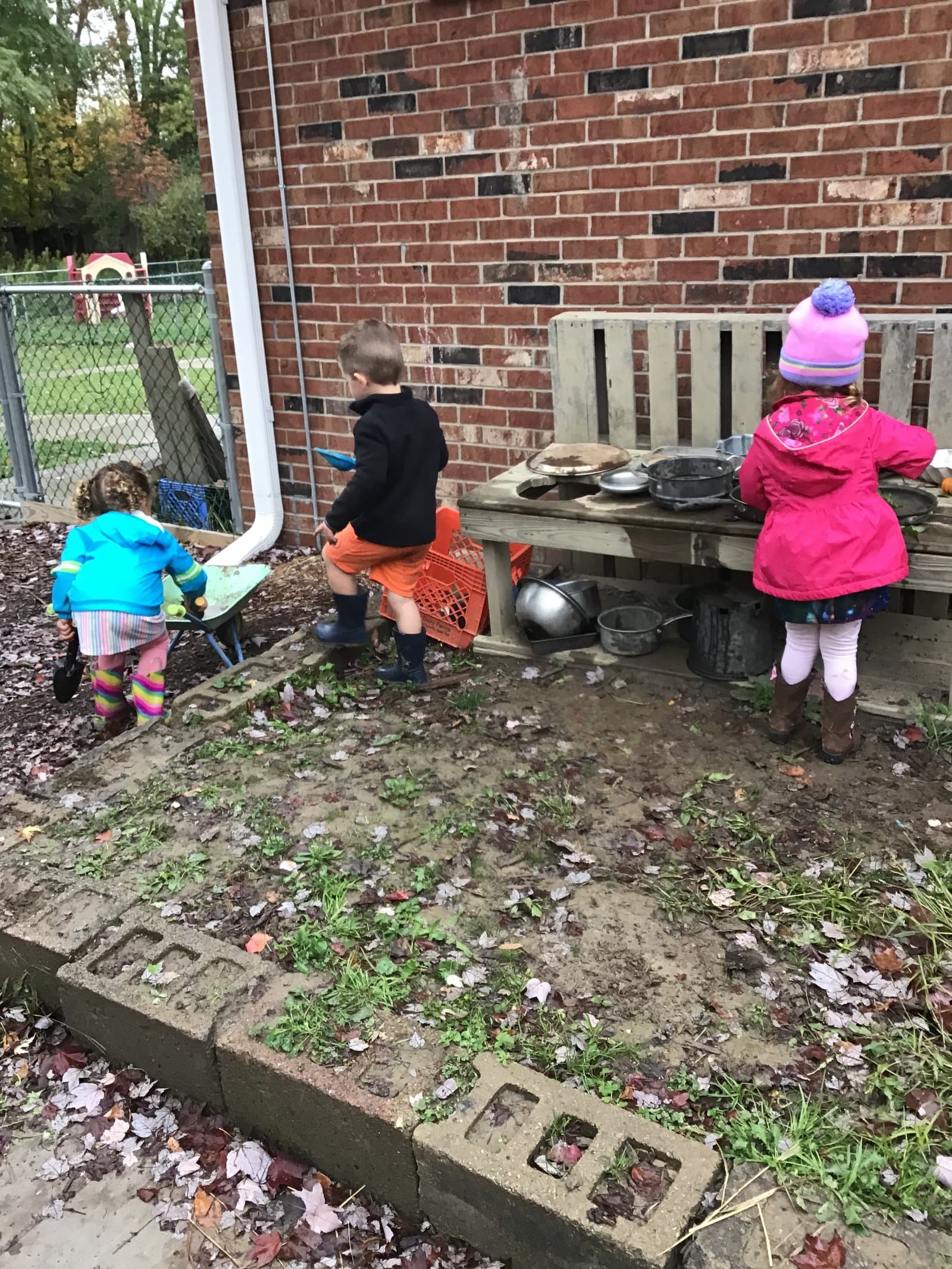 Great Oaks children at the outdoor mud kitchen — open ended sensory play at Little Acorns